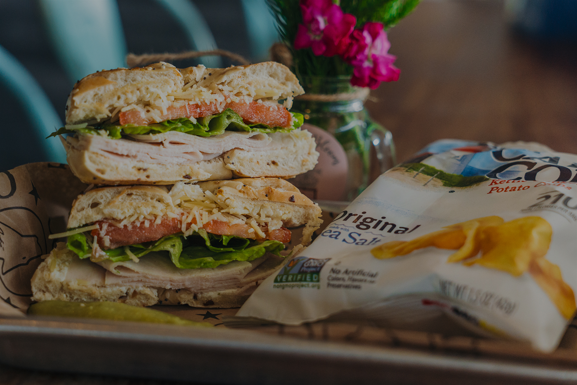 Parm bagel with a side of chips from coyote coffee.